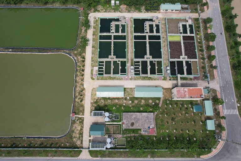 Bird's eye view of a water treatment facility in Hiệp Hòa, Bac Giang, Vietnam showing ponds and infrastructure.