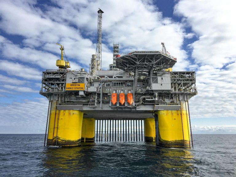Majestic offshore oil platform in Norway's North Sea, under blue skies.