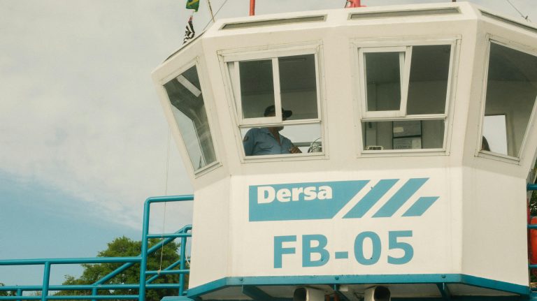 Control tower featuring 'Dersa' logo with person inside, clear sky in the background.