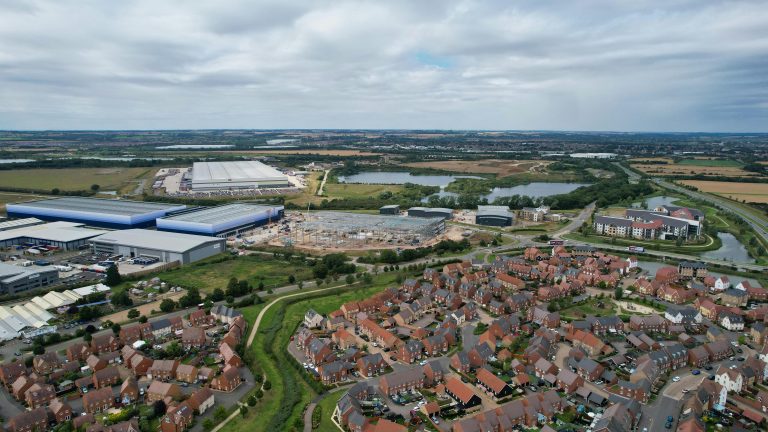 Aerial photograph of houses and industrial buildings in Bedford, England, on a cloudy day.